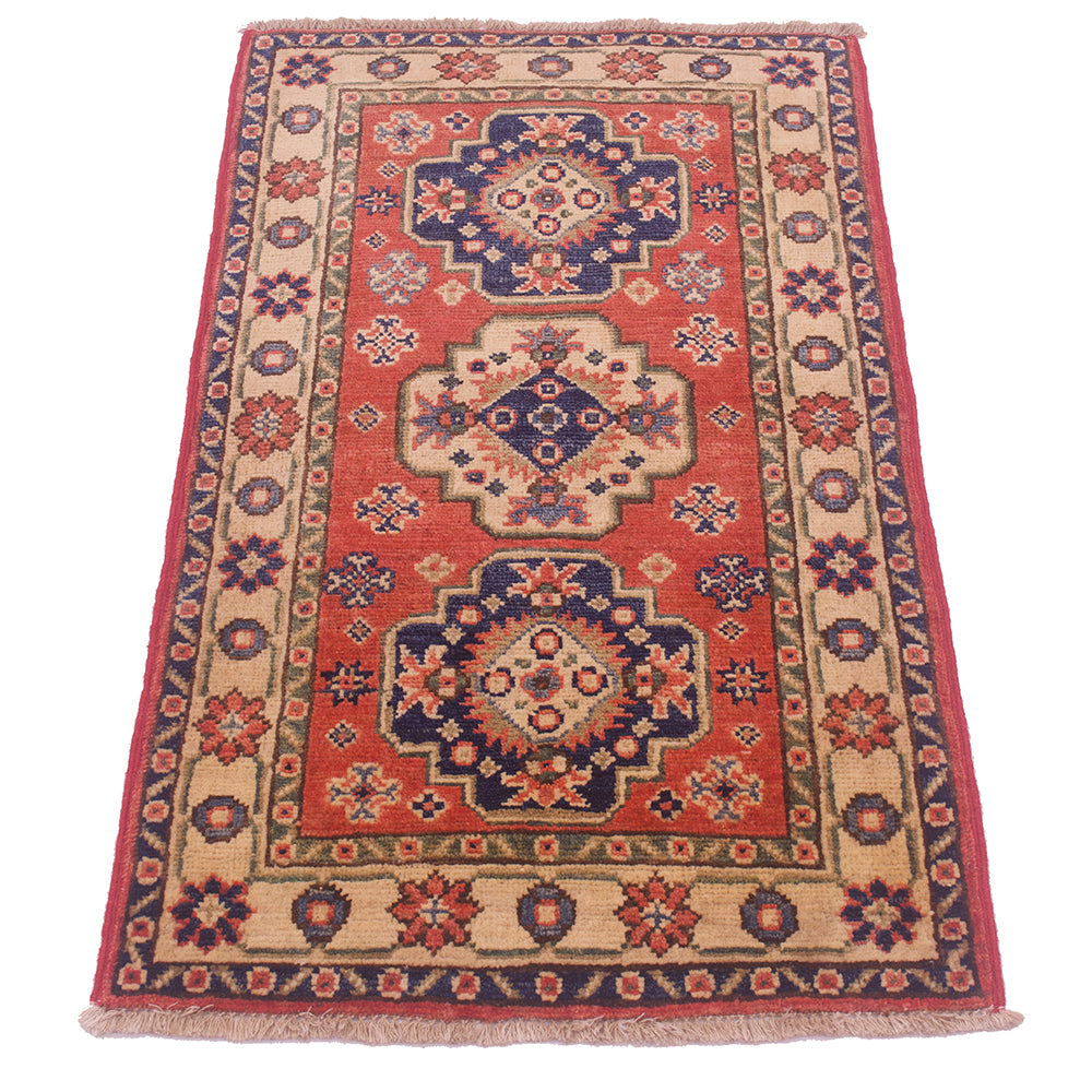 A traditional rectangular Kazak Mat with a red field, beige borders, and navy blue medallions, shown flat against a white background.