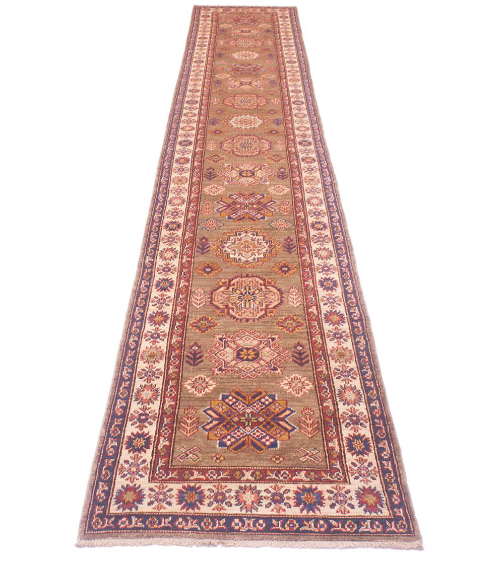 A long handmade Afghan runner with an intricate traditional pattern in beige, rust red, blue, and brown, shown flat against a white background.