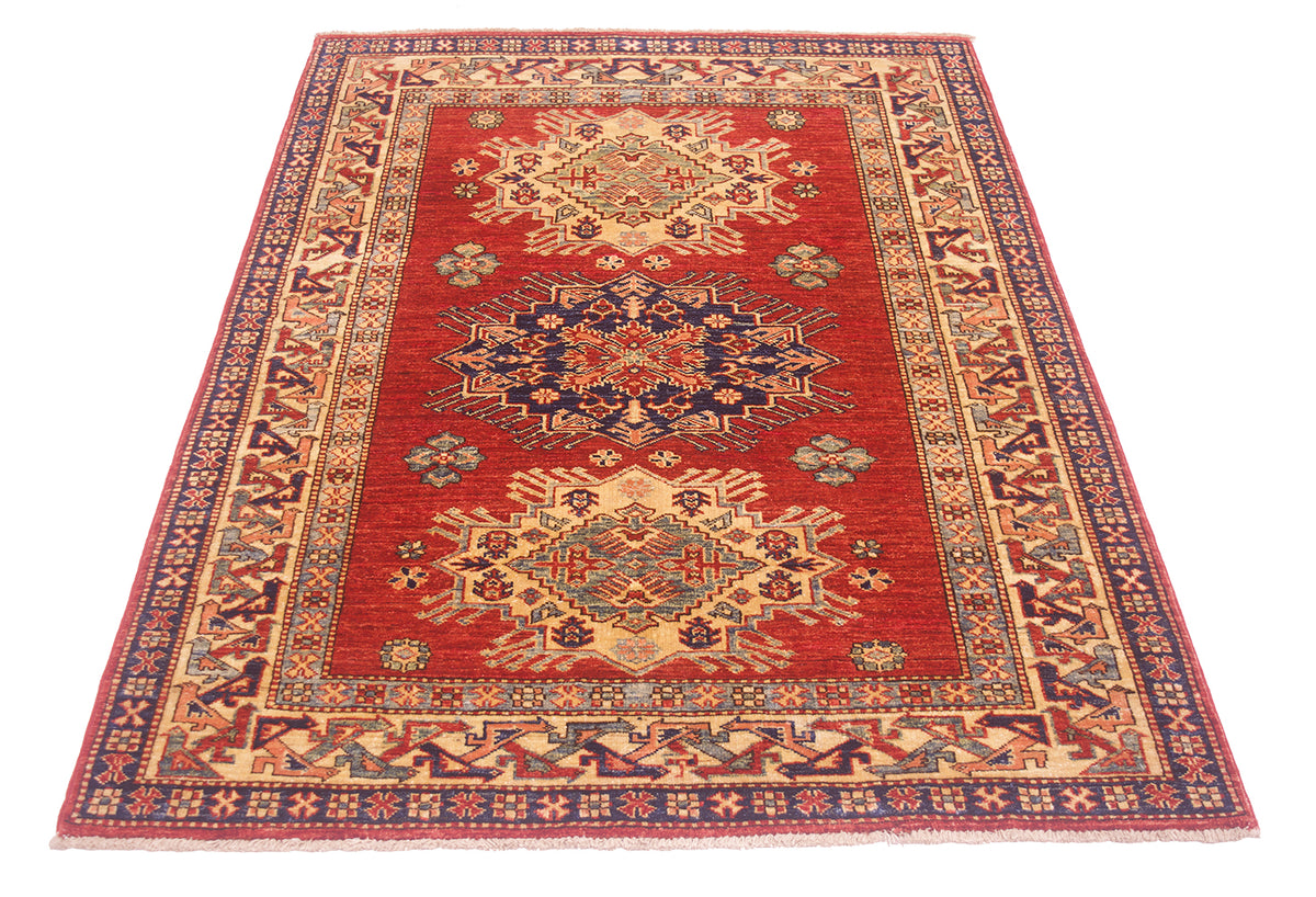 A rectangular traditional Afghan supreme Kazak rug with a red field, featuring two large central medallions and an ornate patterned border in beige, navy, and blue tones, shown on a plain white background.