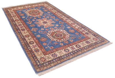 A rectangular traditional Afghan fine Kazak rug with a blue field, beige and red borders, and cream fringe, photographed on a plain white background.
