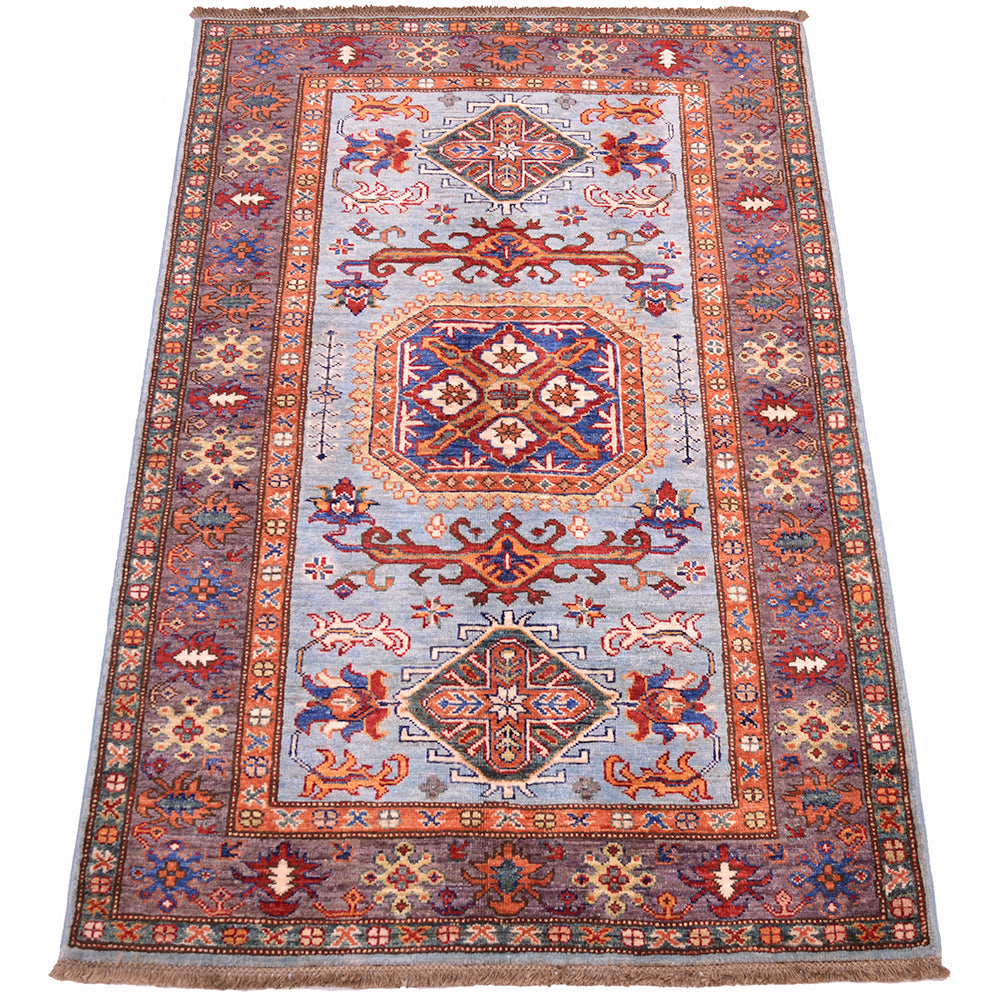 A traditional oriental fine Afghan Kazak rug with a light blue field, featuring a large central medallion and intricate geometric patterns in rust red, orange, brown, and navy blue. The rug is shown flat against a clean white background.