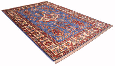 A rectangular area rug with a traditional Persian-style design, featuring a blue center field, red and beige borders, and intricate floral motifs, shown on a plain white background.