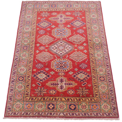 A traditional rectangular Afghan Kazak area rug with a vibrant red field, featuring a central medallion and geometric motifs in blue, beige, and green, surrounded by a patterned border.
