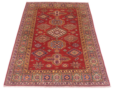 A traditional rectangular fine Afghan Kazak area rug with a deep red field, featuring a central medallion pattern and an ornate multi-colored border in blue, gold, and beige tones, shown flat against a white background.