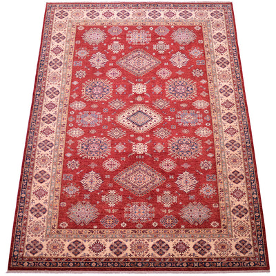 A traditional 9x12 oriental Kazak area rug with a deep red field, featuring a central medallion and intricate geometric patterns in beige, navy, and blue, surrounded by a wide beige and navy border.