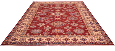 A traditional 12x9 Large handmade red fine Kazak carpet with a deep red field, beige and navy blue geometric borders, and a central medallion pattern, shown from an elevated perspective against a white background.
