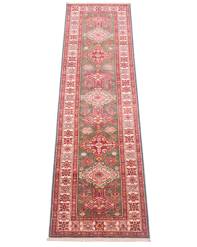 A long fine handmade green Afghan Kazak Runner with an intricate traditional pattern in red, green, beige, and blue, shown flat against a white background.