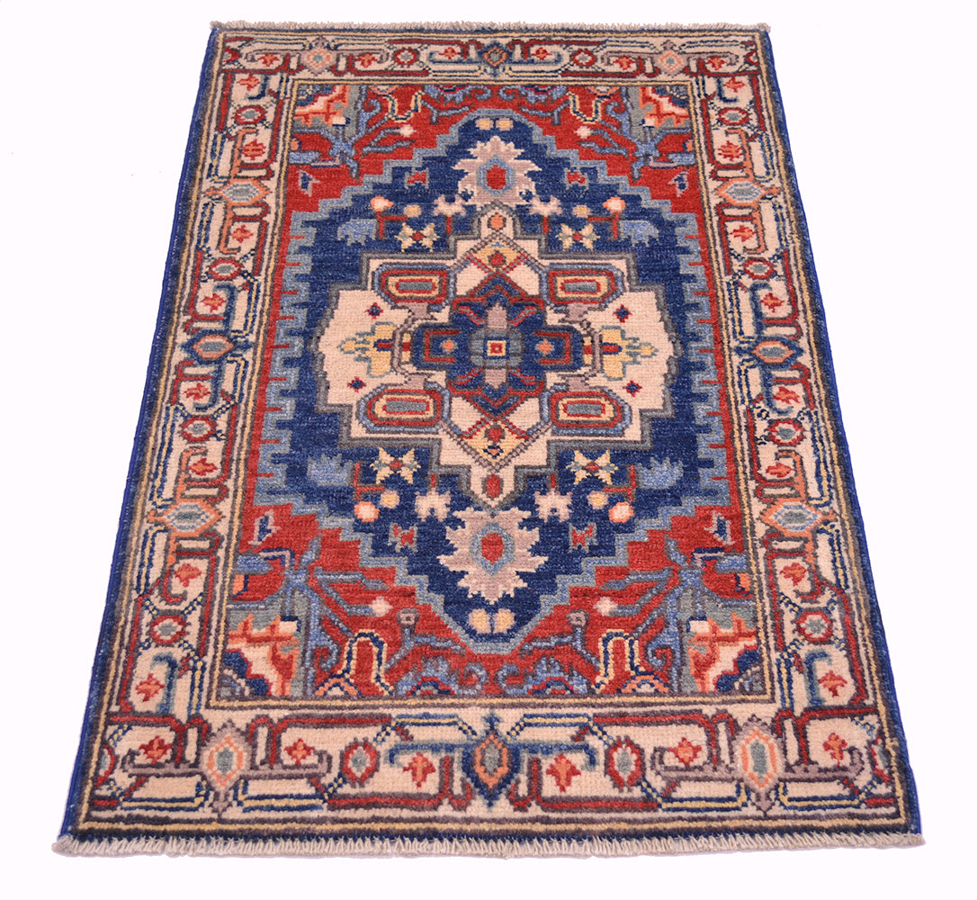 Heriz-style Kazak rug with central floral medallion in blue, red, and cream colors.