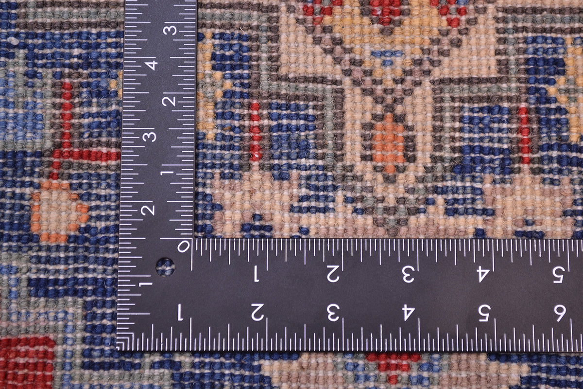 Kazak rug weave shown with measuring tape for size scale, blue and cream ground.