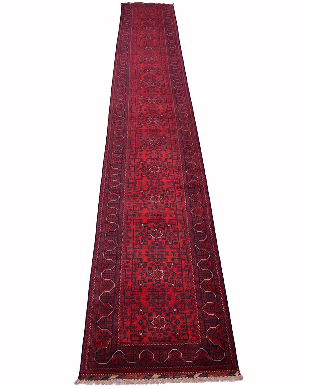 A long, narrow red Afghan runner rug with intricate dark blue and black geometric patterns and traditional borders, shown  against a white background.