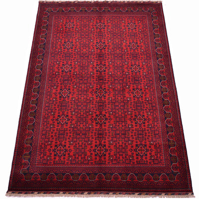 A traditional afghan area rug with a deep red field, dark navy blue geometric patterns, and a matching dark border with fringe on the top and bottom.