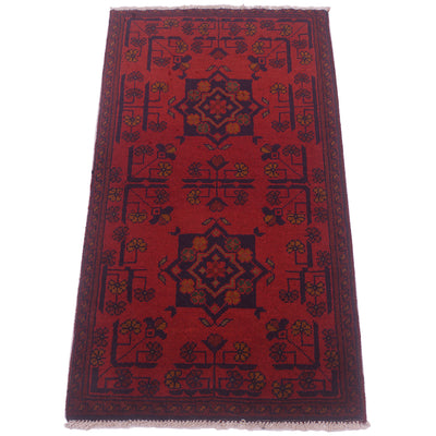 A rectangular red afghan area rug with a traditional geometric pattern in dark navy blue and accents of mustard yellow, shown flat against a white background.