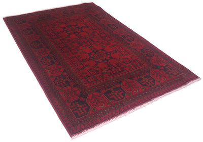 A rectangular red and black patterned Afghan rug with a traditional geometric border and fringe, shown on a plain white background.