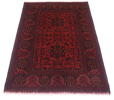 A traditional rectangular afghan area rug with a deep red field, dark navy and black geometric borders, and small gold accents, shown flat against a white background.