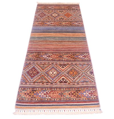 A long rectangular Afghan Khorjin design runner with a traditional geometric pattern in warm terracotta, rust, beige, brown, and muted blue tones, finished with white fringe on both ends.