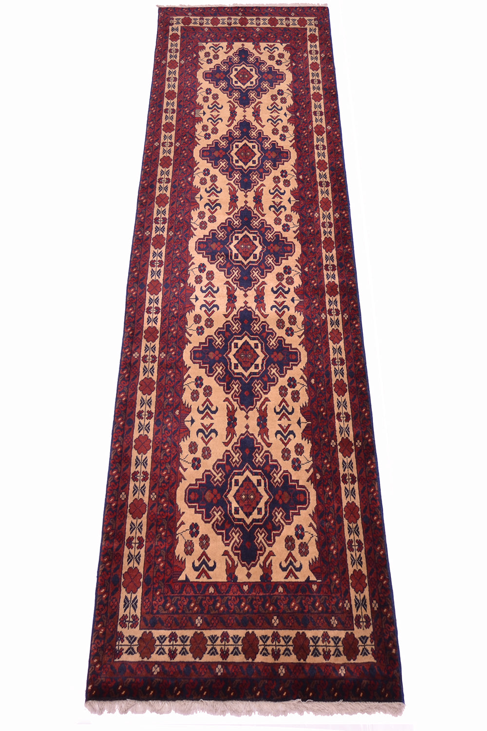 A long rectangular area runner with an intricate geometric and floral pattern in deep red, navy blue, beige, and cream, shown flat against a white background.