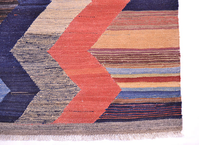 Kilim rug edge with multicolor chevrons and striped background, short fringe