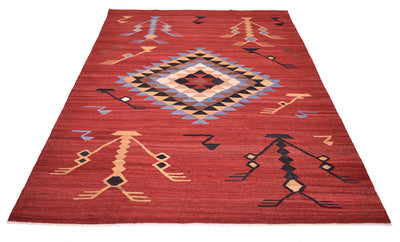 A rectangular red Labijar Afghan Kilim area rug with a geometric pattern, featuring a large central diamond and stylised figures in beige, black, blue, and brown.