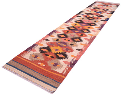 A 13ft long rectangular handwoven Labijar Kilim runner rug with a geometric tribal pattern in orange, red, beige, black, and purple, shown on a plain white background.