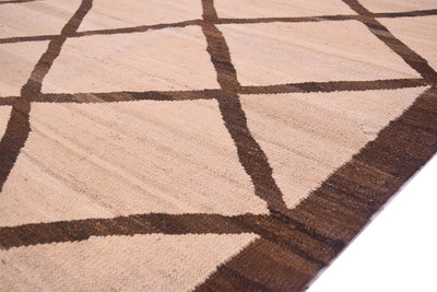 A close-up of a Tribal style handwoven Afghan Kilim with a geometric diamond pattern in beige and dark brown, showing the texture and corner detail.