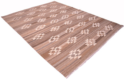 A Handwoven natural Labijar Kilim rug with a brown wood-grain texture and a repeating cream geometric pattern, shown at an angle on a white background.