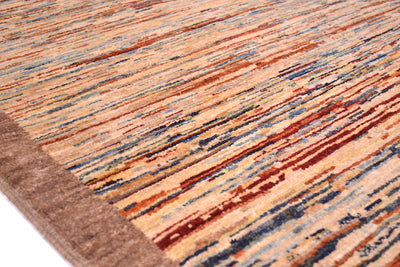 Close-up of a hand-knotted Afghan Gabbeh stripy rug with a multicolour abstract pattern of horizontal brushstrokes in beige, rust red, blue, and brown, featuring a solid brown border.