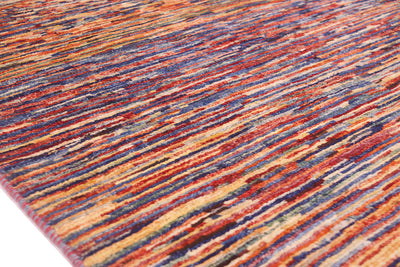 A close-up of a textured hand-knotted Afghan modern rug featuring a multicolour abstract pattern of horizontal brushstroke-like lines in red, orange, blue, yellow, and brown.