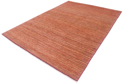 A rectangular striped Gabbeh carpet with a textured, woven linear pattern in warm rust, terracotta, and reddish-brown tones, shown at an angle on a plain white background.