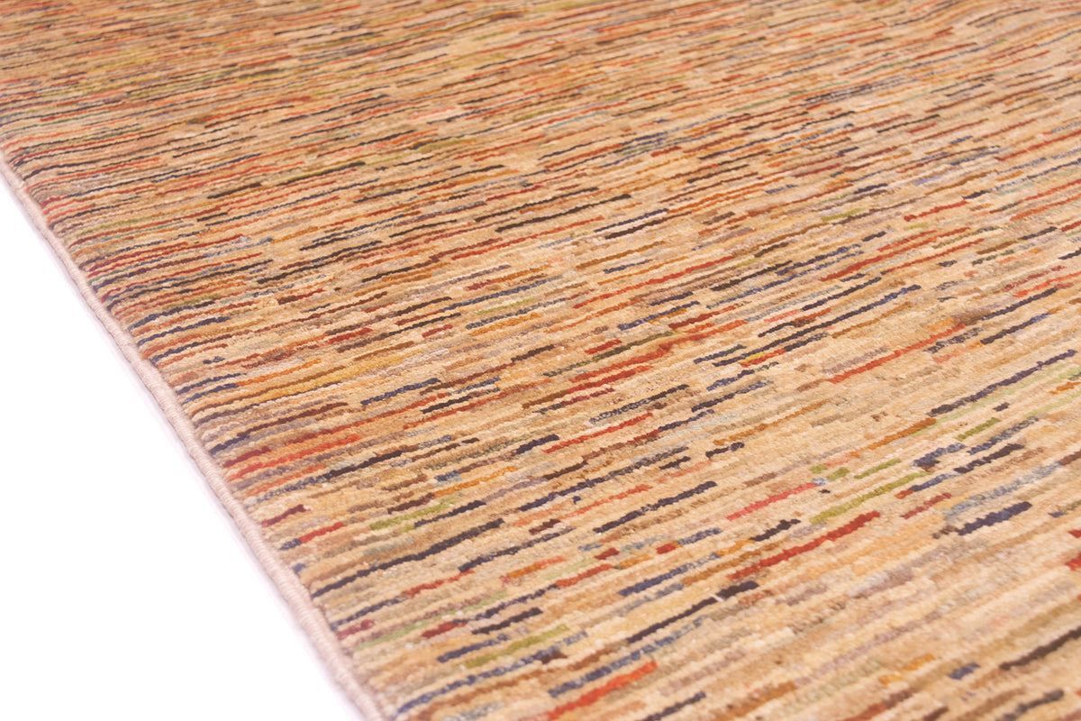 Close-up of a textured Afghan Gabbeh carpet with a multicolour linear pattern in beige, orange, brown, and grey on a white background.