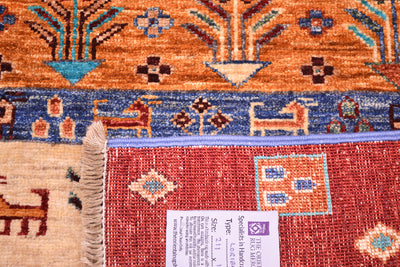 Close-up of the underside corner of a hand-knotted woollen Afghan Loribaft patterned rug showing multiple colour bands and a grey product tag with size and care information.