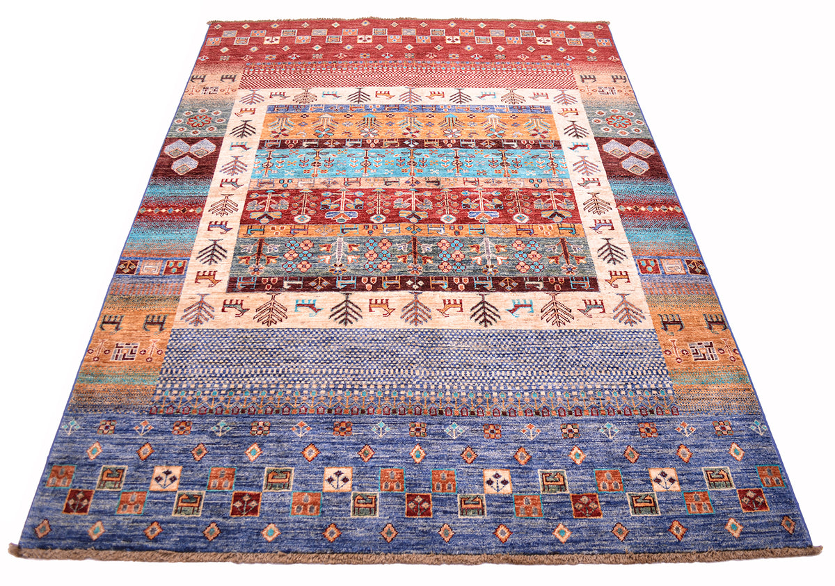 A rectangular Afghan Loribaft area rug with a complex, multi-coloured geometric and tribal pattern, featuring bands of blue, red, orange, beige, and brown on a white background.