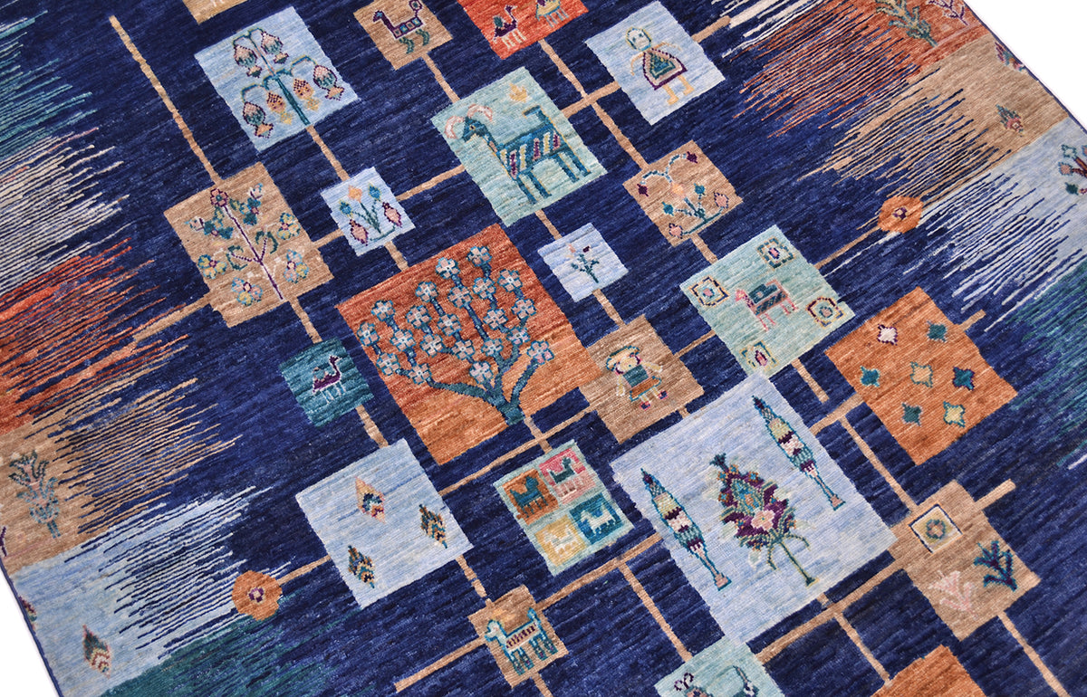 Loribaft carpet close-up with patchwork squares featuring trees and decorative icons