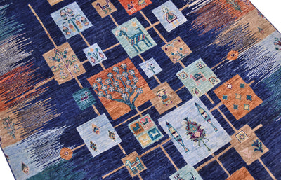 Loribaft carpet close-up with patchwork squares featuring trees and decorative icons