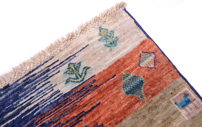 Loribaft carpet corner with short fringe and orange, blue, and beige geometric motifs
