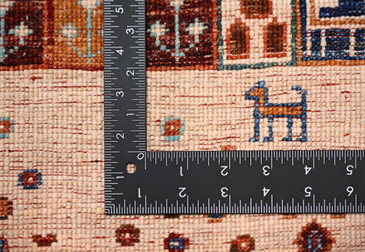 Hand-knotted Afghan Loribaft Gabbeh rug close-up with ruler showing the scale of the knotting and small geometric motifs.