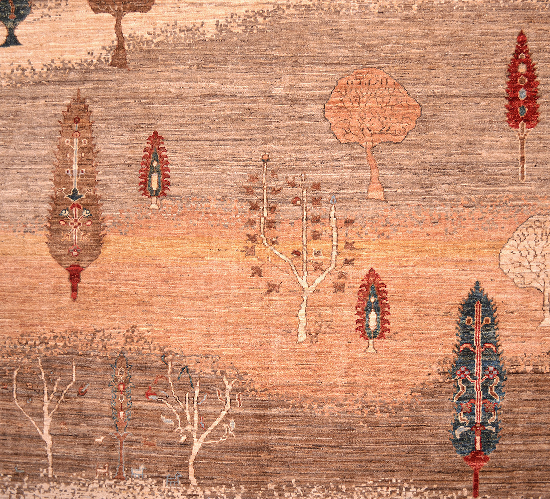 A close-up of a Pictorial hand-knotted Loribaft carpet pattern featuring stylized trees and botanical motifs in warm tan, rust, beige, brown, red, and blue tones.