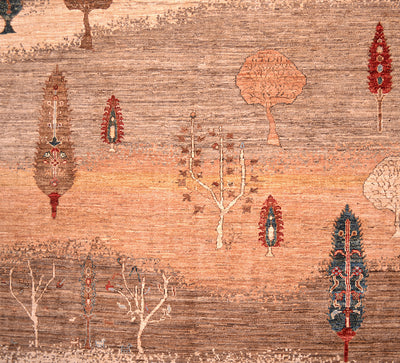 A close-up of a Pictorial hand-knotted Loribaft carpet pattern featuring stylized trees and botanical motifs in warm tan, rust, beige, brown, red, and blue tones.