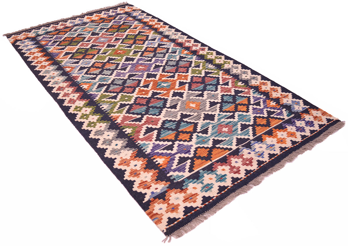 A 2x1m rectangular modern Maimana colourful Afghan kilim rug with a complex geometric diamond pattern in orange, blue, beige, and green on a dark navy base, shown from an angled overhead view on a white background.