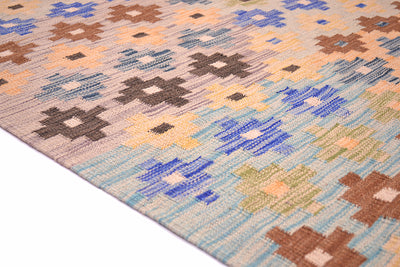 A close-up of a handwoven Afghan multicolour Kilim runner with a geometric pattern in beige, blue, brown, and yellow, shown on a white background.