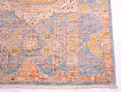 Corner of handkotted runner showing cotton fringes and geometric border and field decorative devices