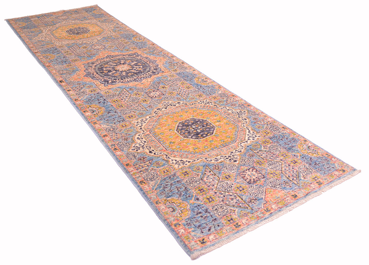 Angled view of Mamluk runner with intricate geometric designs and filled field.