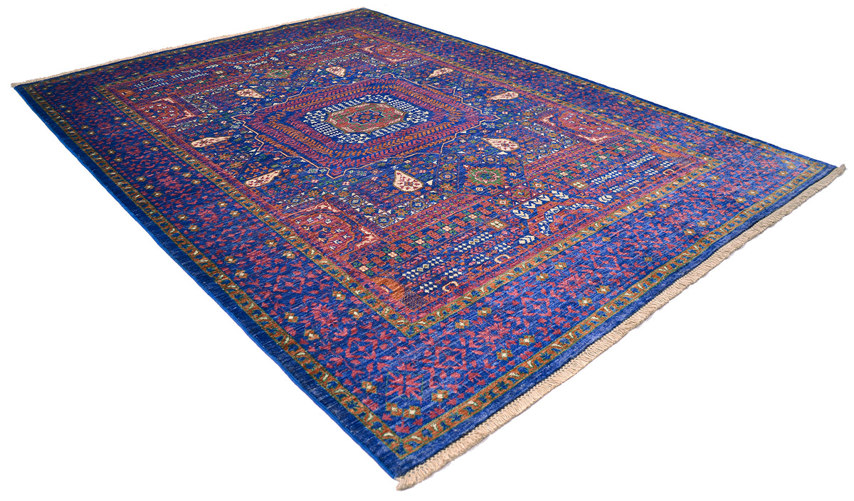 Colourful geometric carpet on white background.