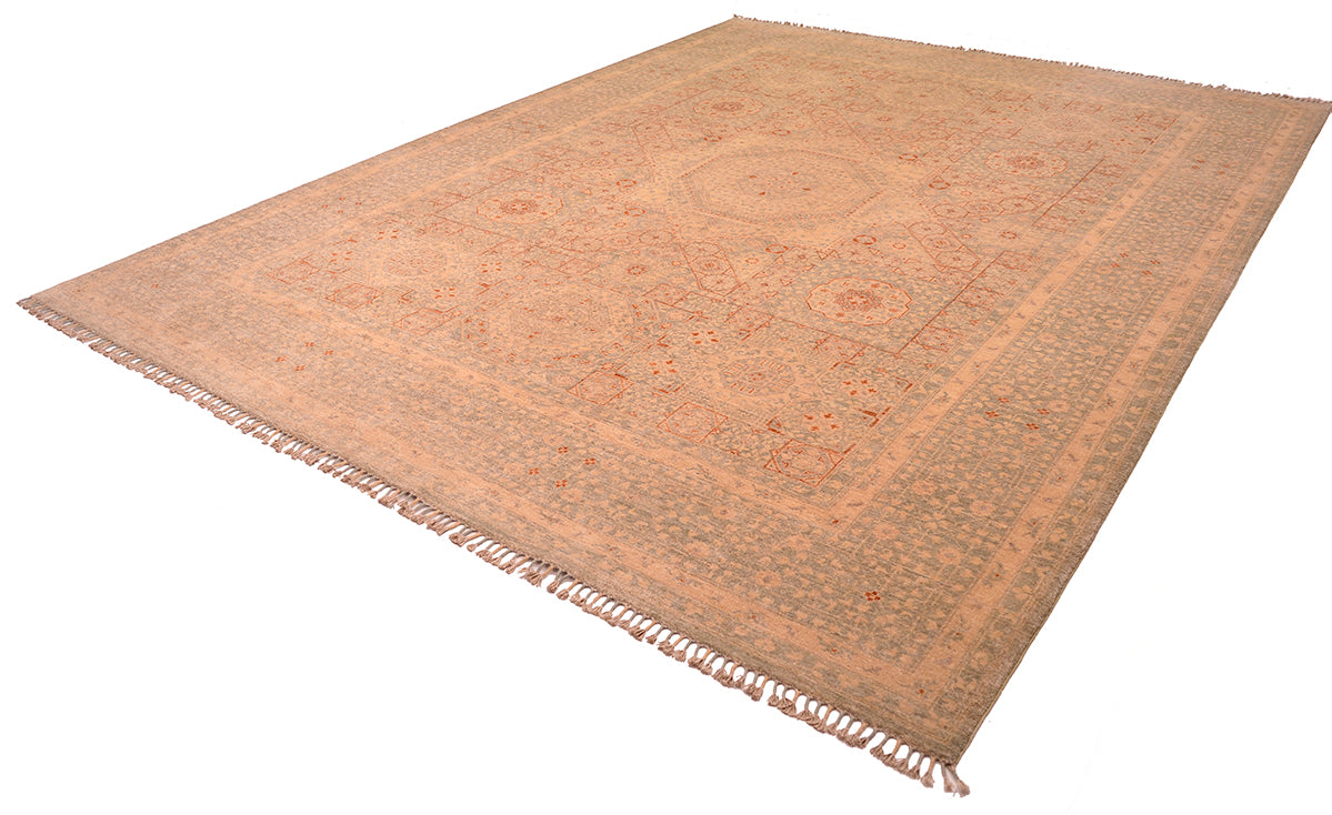 Angled view of soft coloured handwoven carpet on white background.