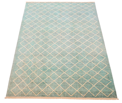 Overall view of modern carpet wth oure wool pile woven on cotton warps. Topaz and sea green-blue turquoise main field colour with natural cream/ beige lattice design.