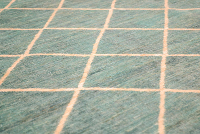 View and close up detail of Afghan Carpet in light turquoise and golden light cream/ beige simple lattice. pattern.