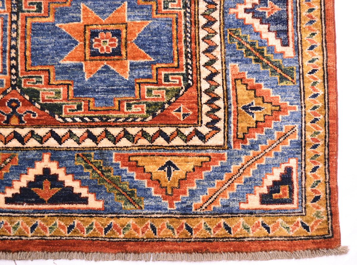 Corner design of afghan handmade memling gul carpet with variety of colours in pile made with natural vegetable dyes. Woven on cotton  foundation warps ( the fringes)