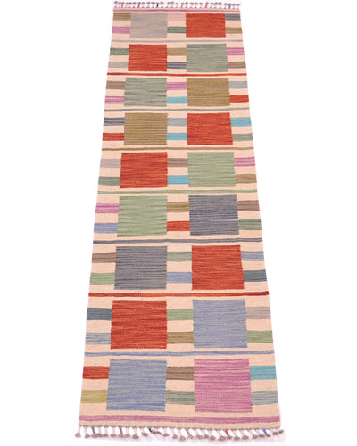 A 2m long rectangular handwoven Modern Kilim short runner rug with a multicolour geometric pattern of coloured squares and stripes, finished with white fringe tassels on the top and bottom, shown flat against a white background.