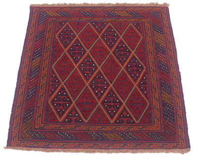 A square woven Mushwani Afghan rug with a geometric diamond pattern in red, navy blue, and orange, featuring a fringed top and bottom edge, shown against a plain white background.