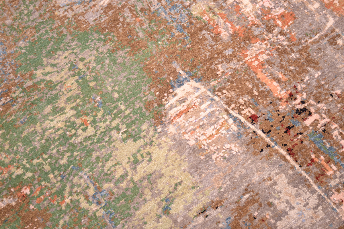 Close up detail of handwoven carpet with modern abstract deisgn with raised silk highlights with grey, ligth bronze and green-grey wool pile ground.