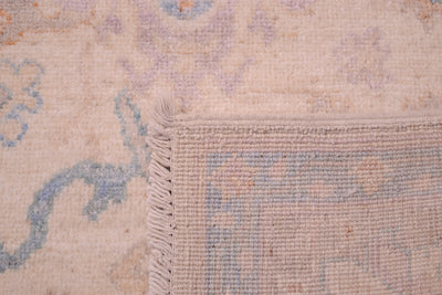 Reverse  of Pastel coloured  Oushak rug with back of knots and cotton warp fringe.